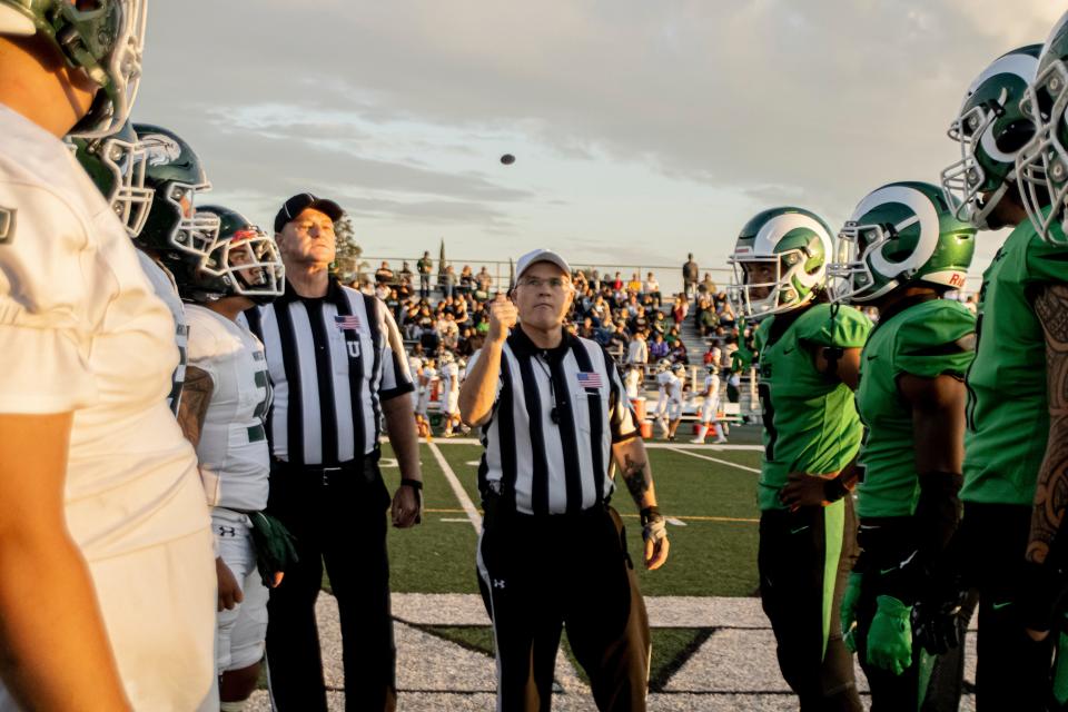 Referee begins the game between St. Mary's and Manteca football captains with a coin toss at St. Mary’s High School in Stockton on Friday, Sept. 1, 2023.