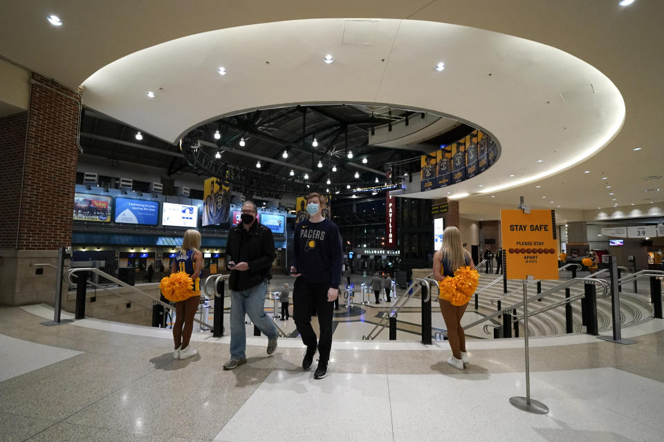 Fans arrive for an NBA basketball game between the Indiana Pacers and the Dallas Mavericks, Wednesday, Jan. 20, 2021, in Indianapolis. (AP Photo/Darron Cummings)