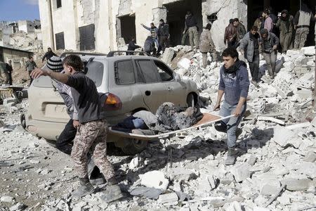 Residents carry an injured woman on a stretcher in a site hit by what activists said were airstrikes carried out by the Russian air force in the rebel-controlled area of Maaret al-Numan town in Idlib province, Syria January 9, 2016. REUTERS/Khalil Ashawi