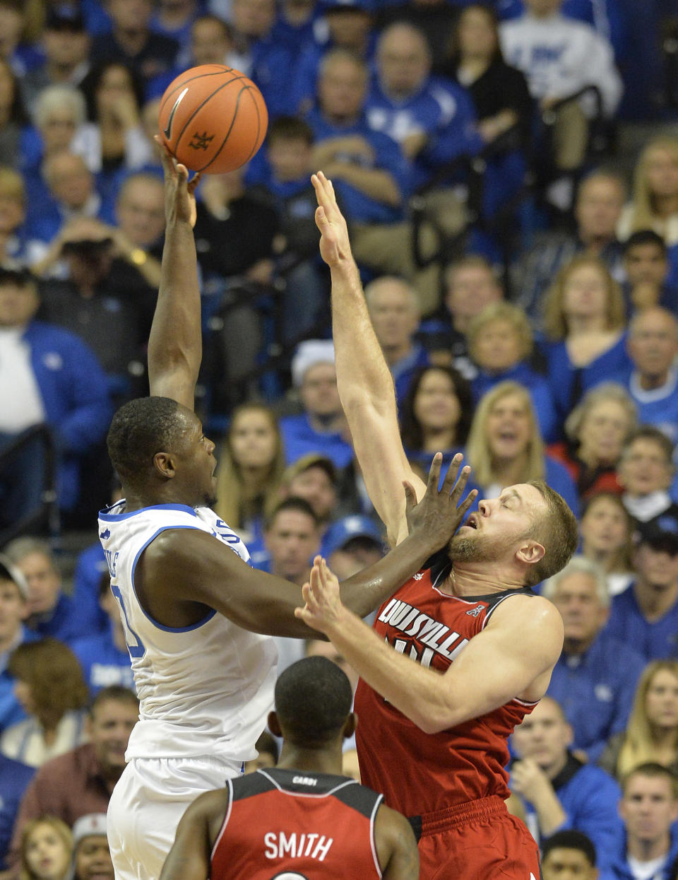 Kentucky's Julius Randle, left, shoots over the defense of Louisville Stephan Van Treese during the first half of an NCAA college basketball game on Saturday, Dec. 28, 2013, in Louisville, Ky. (AP Photo/Timothy D. Easley)