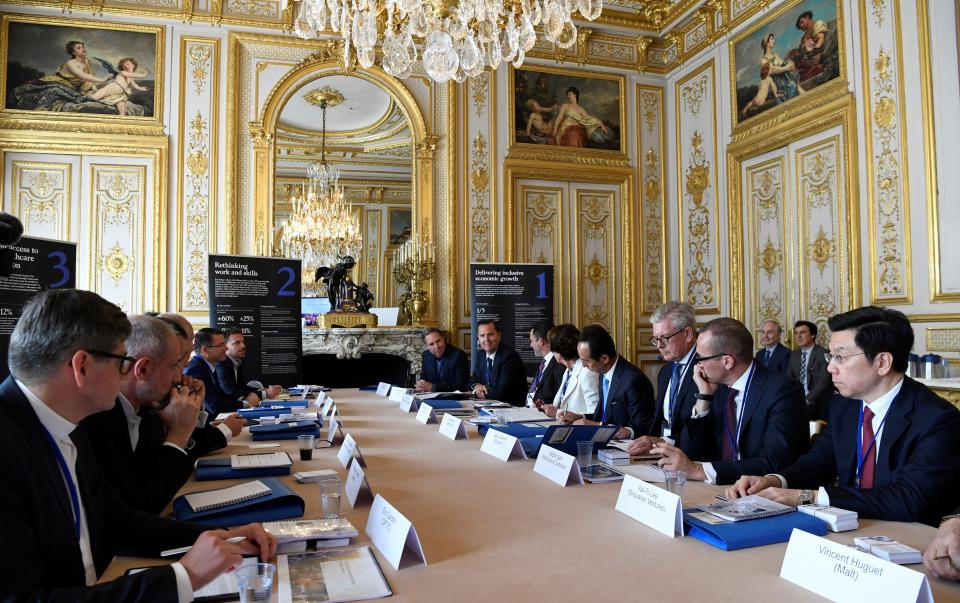 Delegates gather during a "Tech For Good" summit in Paris, Wednesday, May 15, 2019. Several world leaders and tech bosses are meeting in Paris to find ways to stop acts of violent extremism from being shown online. (Bertrand Guay, Pool Photo via AP)