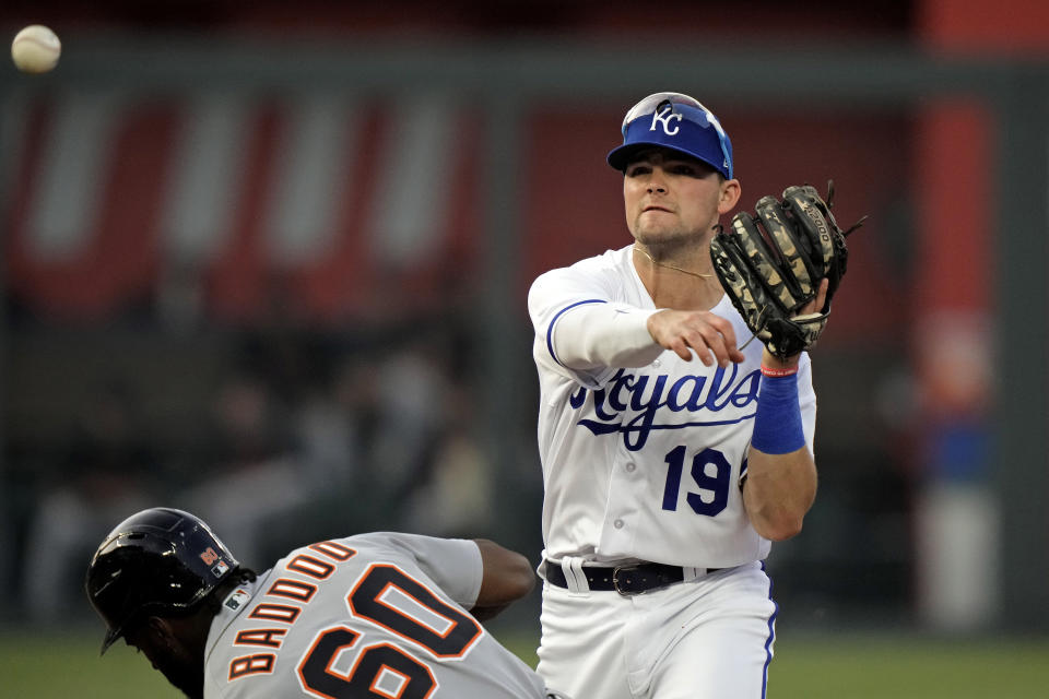 Kansas City Royals second baseman Michael Massey throws to home for the double play hit into by Detroit Tigers' Jake Rogers after forcing Akil Baddoo (60) out at second during the fifth inning of a baseball game Tuesday, May 23, 2023, in Kansas City, Mo. (AP Photo/Charlie Riedel)
