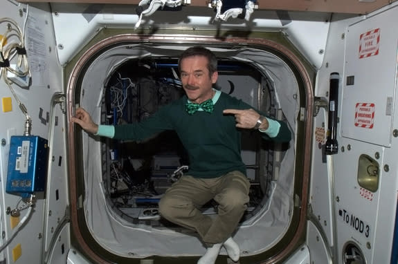 Canadian astronaut Chris Hadfield floats inside the International Space Station clad all in green for St. Patrick's Day on March 17, 2013.