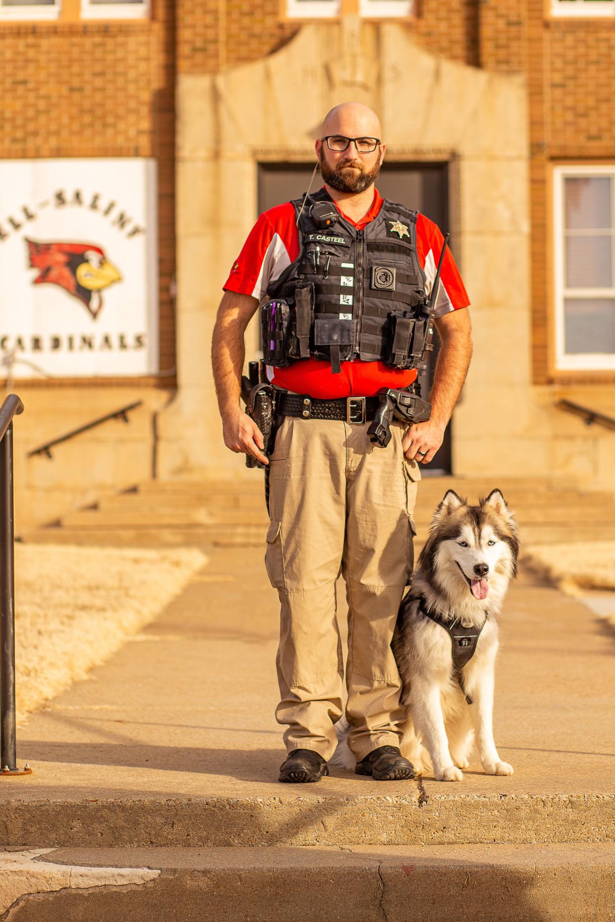 Saline County Deputy Tyler Casteel stands with his K-9 Therapy Dog, Jax, at Ell-Saline High School.