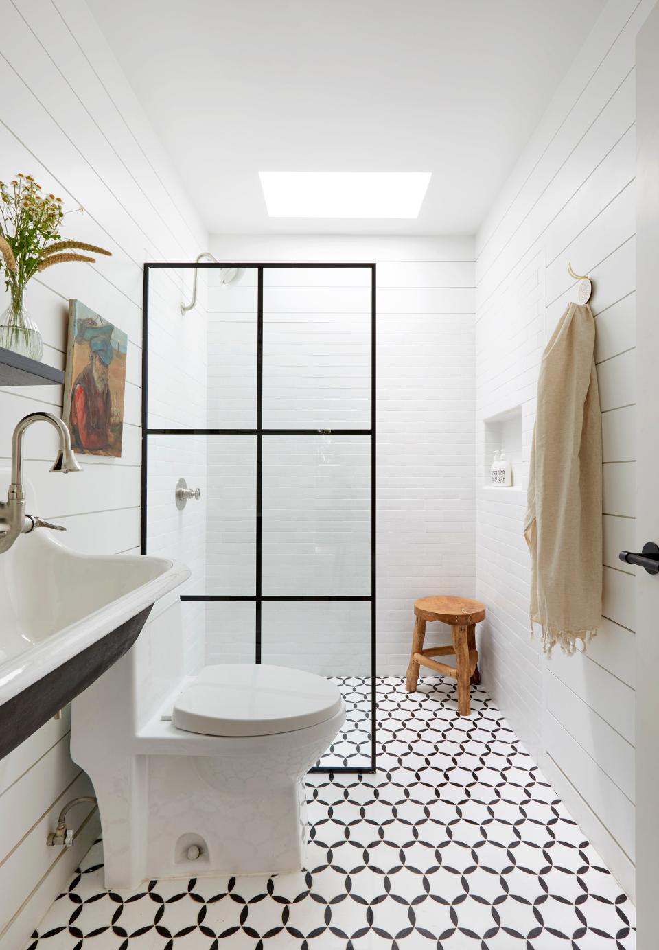 AFTER: The guest bathroom contains a marble mosaic floor and Clé Tile thin glazed brick seamless shower.