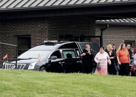 Members of the Ohio Crisis Response Team assist a mourner after the funeral for six members of the Rhoden family, who were shot to death in rural Pike County on April 22, at Dry Run Church of Christ in West Portsmouth, Ohio, U.S. May 3, 2016. REUTERS/Kyle Grillot