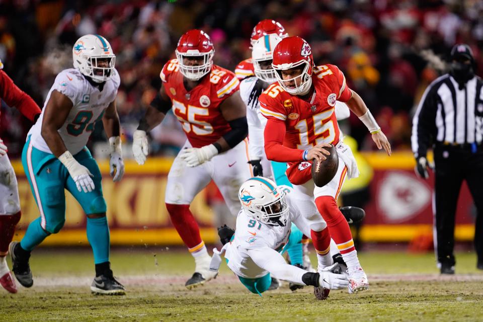 Jan 13, 2024; Kansas City, Missouri, USA; Kansas City Chiefs quarterback Patrick Mahomes (15) runs the ball against Miami Dolphins defensive end Emmanuel Ogbah (91) during the first half of the 2024 AFC wild card game at GEHA Field at Arrowhead Stadium. Mandatory Credit: Jay Biggerstaff-USA TODAY Sports