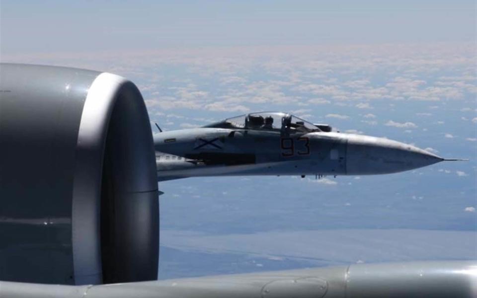 The Russian SU-27 coming so close to the wing of the U.S. RC-135U the Russian pilot can be seen sitting in the cockpit - Credit: Master Sgt. Charles Larkin Sr/ U.S. European Command