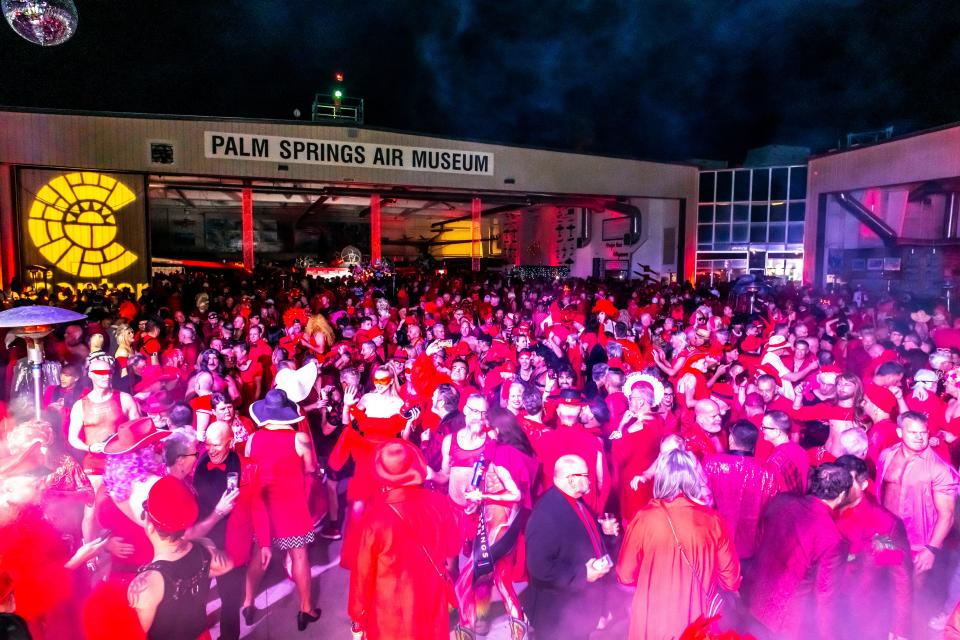 Dancers in red rock out at the LGBTQ Community Center of the Desert's Red Dress/Dress Red Party in Palm Springs, Calif., on March 16, 2024.