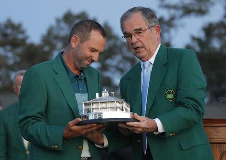 Sergio Garcia of Spain is presented the Masters trophy by Augusta National chairman Billy Payne after winning the 2017 Masters golf tournament at Augusta National Golf Club in Augusta, Georgia, U.S., April 9, 2017. REUTERS/Brian Snyder