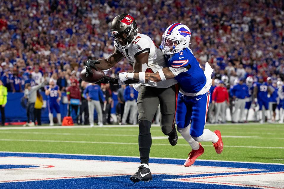 Tampa Bay Buccaneers wide receiver Chris Godwin (14) catches a touchdown in front of Buffalo Bills cornerback Taron Johnson (7) during an NFL football game, Thursday, Oct. 26, 2023, in Orchard Park, NY. (AP Photo/Matt Durisko)