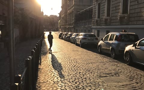 Early morning sunshine hits a road lined with cobbles in the historic heart of Rome - Credit: Nick Squires