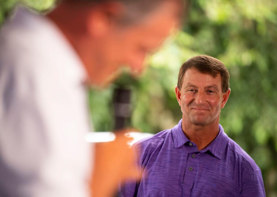 Clemson head football coach Dabo Swinney smiles as Rich Davies, Swinney's business partner, speaks during a preview for the new Walk-On's Sports Bistreaux at 403 College Ave., in Clemson on Wednesday, July 13, 2022.