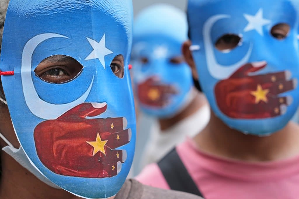 File: Student activists wear masks with the colours of the pro-independence East Turkestan (or Uyghur flags) during a rally to protest the Beijing 2022 Winter Olympic Games  (AP)