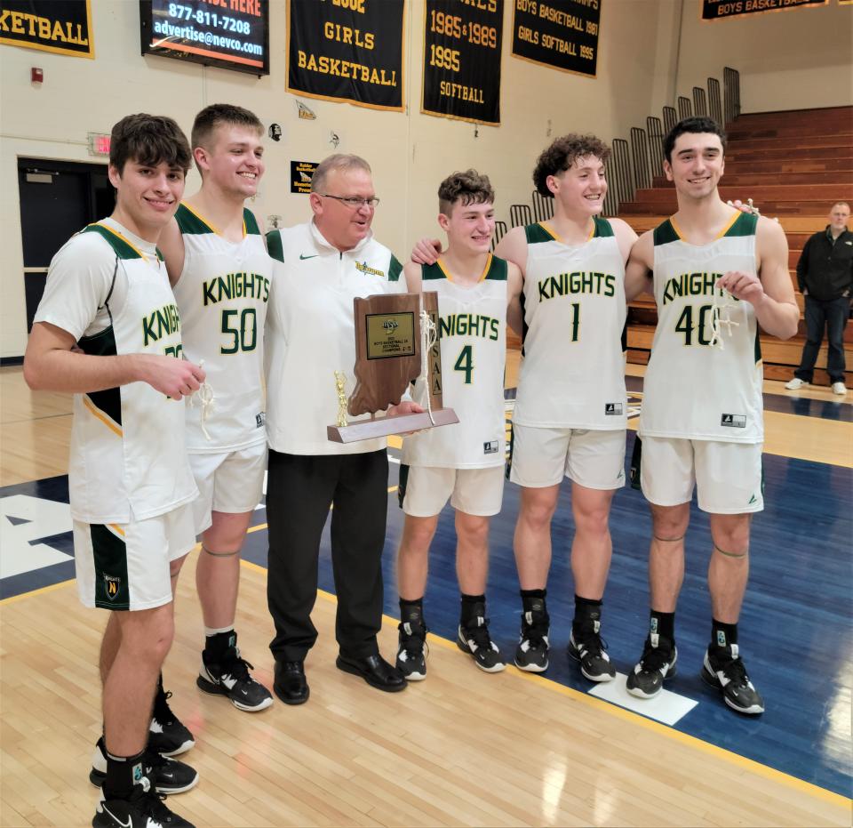 Northeastern head coach Brent Ross takes a picture with his seniors, (left to right) Karsen Scarrette, Caleb Harmon, Keaton Mikesell, Carson Terrell and Grant Luebbe, after winning a sectional championship over Hagerstown March 4, 2023.