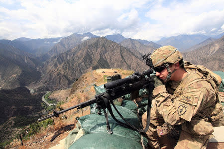 FILE PHOTO: U.S. Army Lieutenant Edward Bachar looks trough his sniper scope at Observation Post Mace in eastern Afghanistan Kunar province, near the border with Pakistan early August 29, 2011. REUTERS/Nikola Solic/File Photo