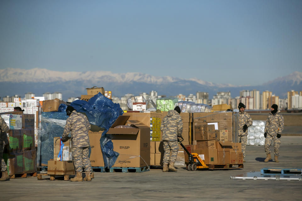 Turkish soldiers prepare aid supplies for the survivors of devastating earthquake at Incirlik military airbase in Adana, southern Turkey, Tuesday, Feb. 14, 2023. Thousands left homeless by a massive earthquake that struck Turkey and Syria a week ago packed into crowded tents or lined up in the streets for hot meals as the desperate search for survivors entered what was likely its last hours. (AP Photo/Emrah Gurel)