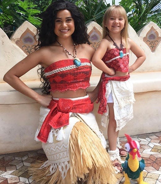 Riley Ruvalcabas dressed as Moana with Moana character at Disney World in Orlando, Florida.