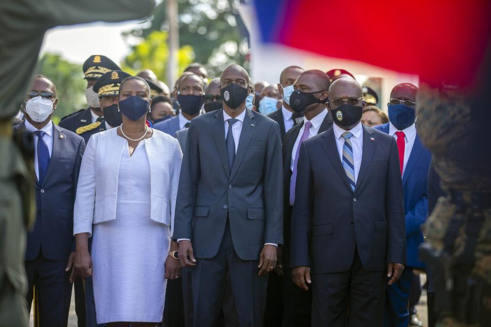 FILE - Haiti's President Jovenel Moise, center, accompanied by his wife Martine, and Prime Minister Joseph Jouthe, front right, stand for their national anthem after placing flowers to honor revolutionary leaders Alexandre Petion and Jean Jacques Dessalines during a ceremony commemorating Haiti's final battle before it secured independence from France in 1804, in Port-au-Prince, Haiti, in this Wednesday, Nov. 18, 2020, file photo. Haitian Prime Minister Joseph Jouthe announced early Wednesday, April 14, 2021, that he has resigned as the country faces a spike in killings and kidnappings and prepares for an upcoming constitutional referendum and general election later this year. (AP Photo/Dieu Nalio Chery, File)