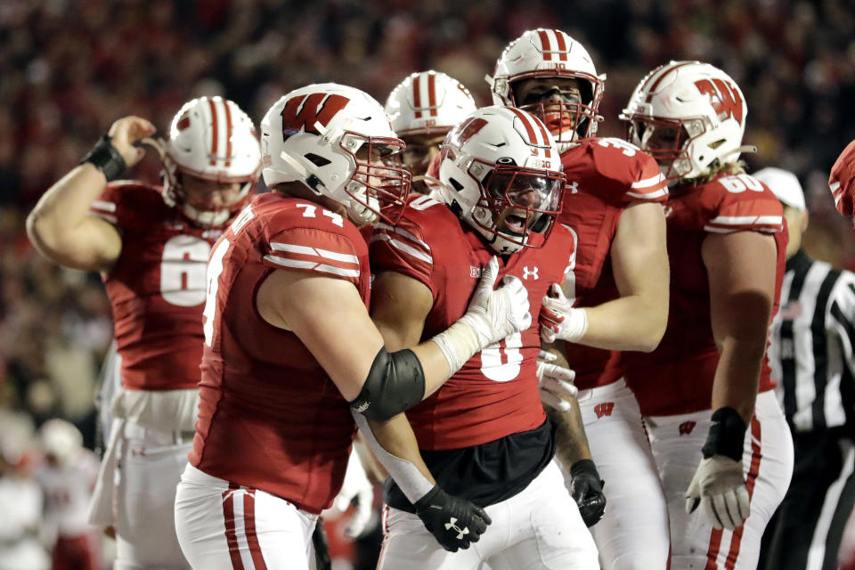 Wisconsin's Braelon Allen is congratulated by teammates during overtime of an NCAA college football game against Nebraska Saturday, Nov. 18, 2023 in Madison, Wis. (AP Photo/Aaron Gash)