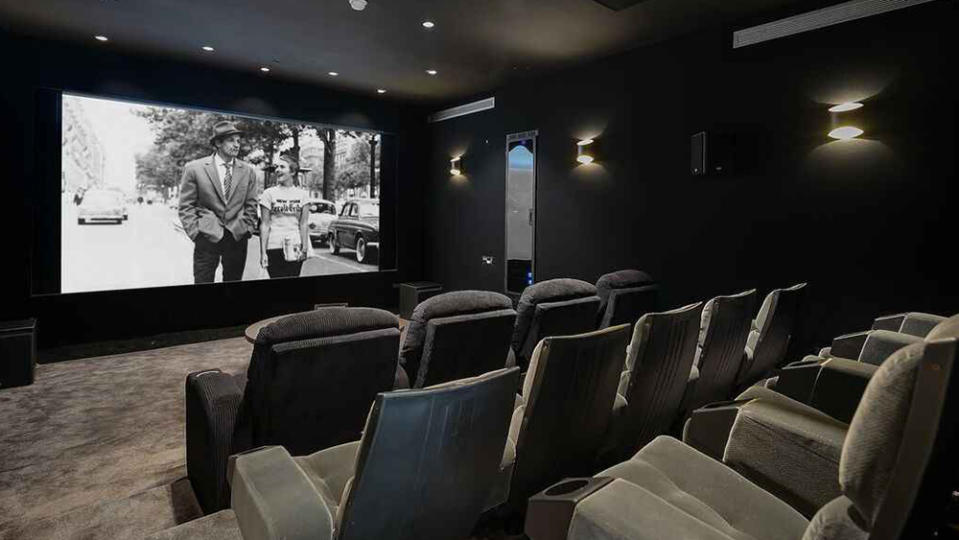 The home’s movie theater with a 15-foot screen. - Credit: Realtor.com