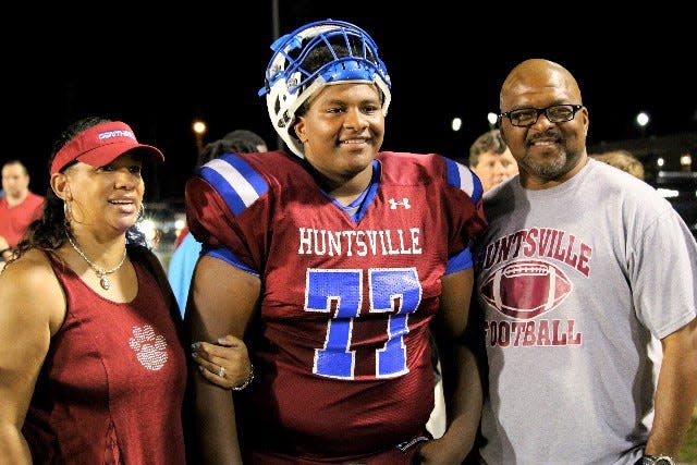 Jalen Spady shares a moment with his parent James and Barbara Spady at Huntsville High School in Huntsville, Ala. James is now an assistant coach at FAMU. Jalen plays on the offensive line