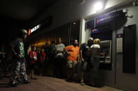 <p>People make line at night at an ATM to withdraw money in San Juan, Puerto Rico, on September 25, 2017, where a 7pm-6am curfew has been imposed following impact of Hurricane Maria on the island. (Photo: Ricardo Arduengo/AFP/Getty Images) </p>