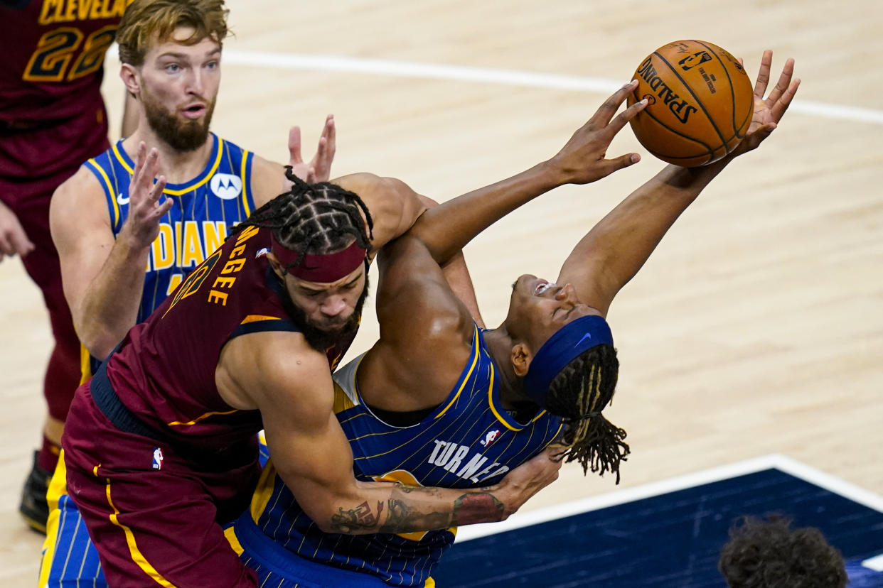 Cleveland Cavaliers center JaVale McGee (6) fouls Indiana Pacers forward Myles Turner (33) as he shoots during the first half of an NBA basketball game in Indianapolis, Thursday, Dec. 31, 2020. (AP Photo/Michael Conroy)