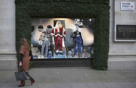 A woman walks past a Christmas window display at a Selfridges store on Oxford Street in London, Britain October 20, 2016. REUTERS/Neil Hall