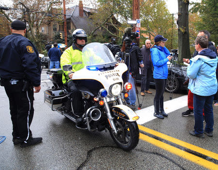 A police officer on motorcycle passes through a roadblock as he responds after a gunman opened fire at the Tree of Life synagogue in Pittsburgh, Pennsylvania, U.S., October 27, 2018. REUTERS/John Altdorfer