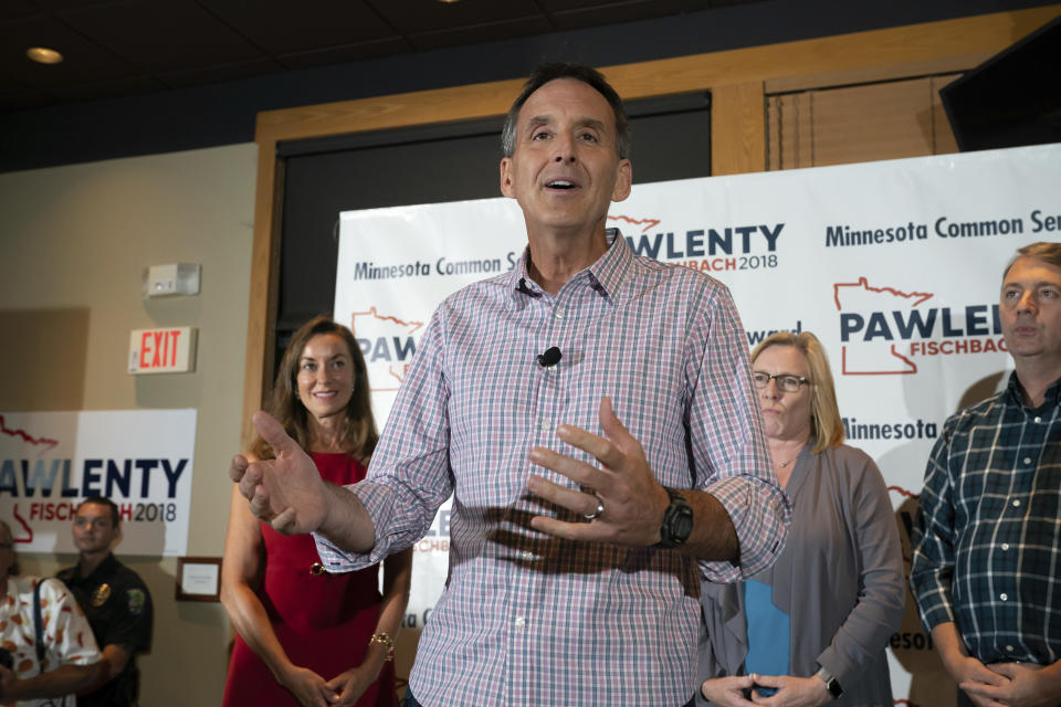 Tim Pawlenty stands with his wife, Mary, background left, and running mate Michelle Fischbach, background second from right, as he concedes his run for governor at his election night gathering at Granite City Food and Brewery, Tuesday, Aug. 14, 2018, in Eagan, Minn. (Glen Stubbe/Star Tribune via AP)