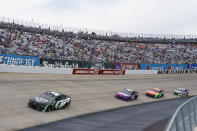 Kyle Larson, left, leads the pack of Alex Bowman, center left, William Byron, center right, and Chase Elliott, right, during a NASCAR Cup Series auto race at Dover International Speedway, Sunday, May 16, 2021, in Dover, Del. (AP Photo/Chris Szagola)