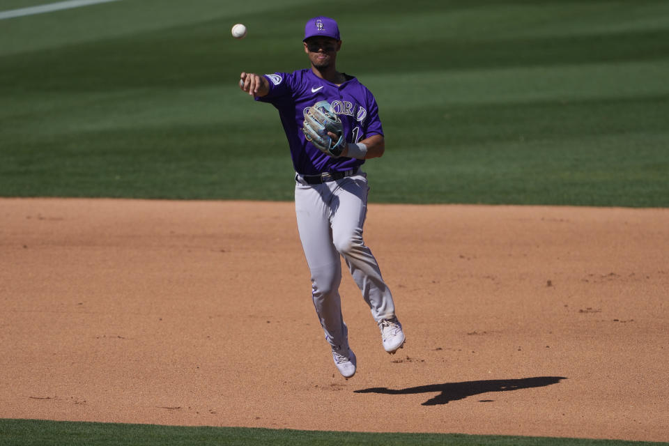 Colorado Rockies' Ezequiel Tovar fields a ground out hit by Los Angeles Angels' Taylor Ward during the fourth inning of a spring training baseball game, Friday, March 8, 2024, in Tempe, Ariz. (AP Photo/Matt York)