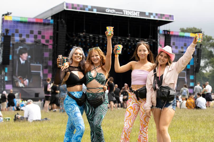 Four girls at TRNSMT pose with drinks in their hands