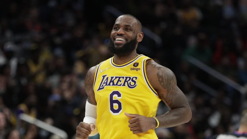 Los Angeles Lakers' LeBron James smiles during the second half of an NBA basketball game against the Washington Wizards