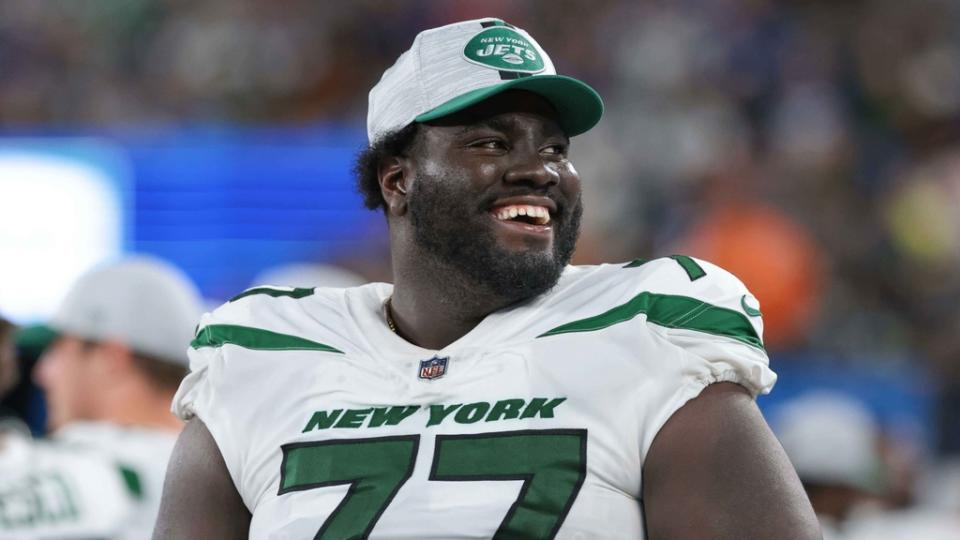 New York Jets offensive tackle Mekhi Becton (77) laughs during the second half against the New York Giants at MetLife Stadium