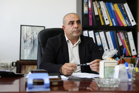 FILE PHOTO: Ramadan Dabash, a civil engineer from East Jerusalem who is running for a seat in city hall of Jerusalem in the upcoming municipal election, sits in his office in East Jerusalem, August 30, 2018. REUTERS/Ammar Awad