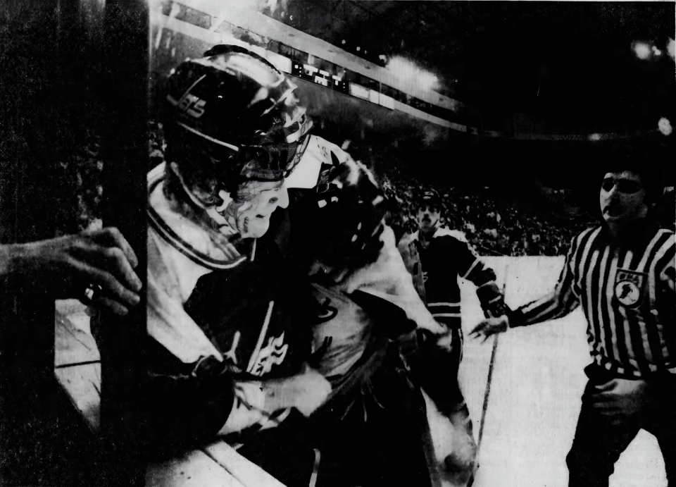 FEBRUARY 9, 1979: Stingers defenseman Barry Melrose applies a headlock to Jets' Scott Campbell in a second period scuffle along the boards at Riverfront Coliseum. Both were assessed five minute major fighting penalties.