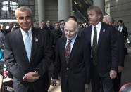 Milwaukee Bucks owner Herb Kohl walks into a news conference after reaching a deal to sell the franchise to New York investment firm executives Marc Lasry, right, and Wesley Edens, left, Wednesday, April 16, 2014, in Milwaukee. (AP Photo/Morry Gash)