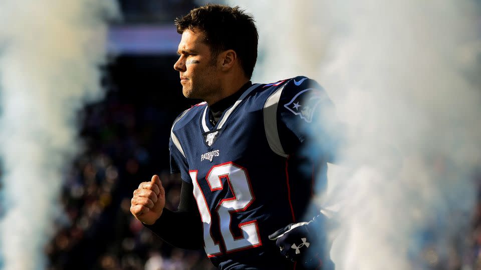Tom Brady #12 of the New England Patriots runs onto the field before a game against the Miami Dolphins at Gillette Stadium on December 29, 2019 in Foxborough, Massachusetts. - Billie Weiss/Getty Images