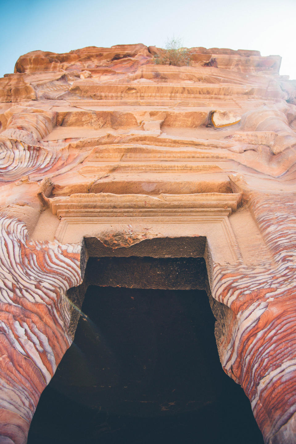 <p>Before entering Petra proper, I scramble up a narrow, sandstone corridor to Siq al-Barid, or Little Petra. At the entrance, a Bedouin man plays a haunting tune on a rababah, an instrument lathered in horse hair and made by stretching the stomach of a goat. Nearby, a boy named Mohammad begins singing a song called <em>da heya</em>, a peaceful greeting for travelers entering the site.</p>