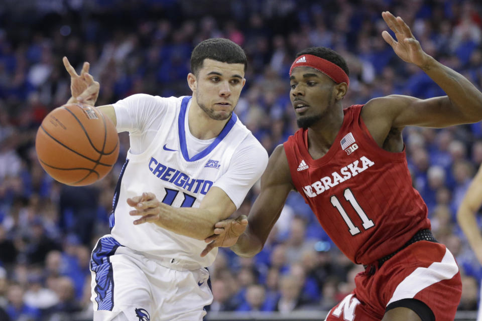 Creighton's Marcus Zegarowski (11) passes the ball away from Nebraska's Dachon Burke Jr., right, during the first half of an NCAA college basketball game in Omaha, Neb., Saturday, Dec. 7, 2019. (AP Photo/Nati Harnik)