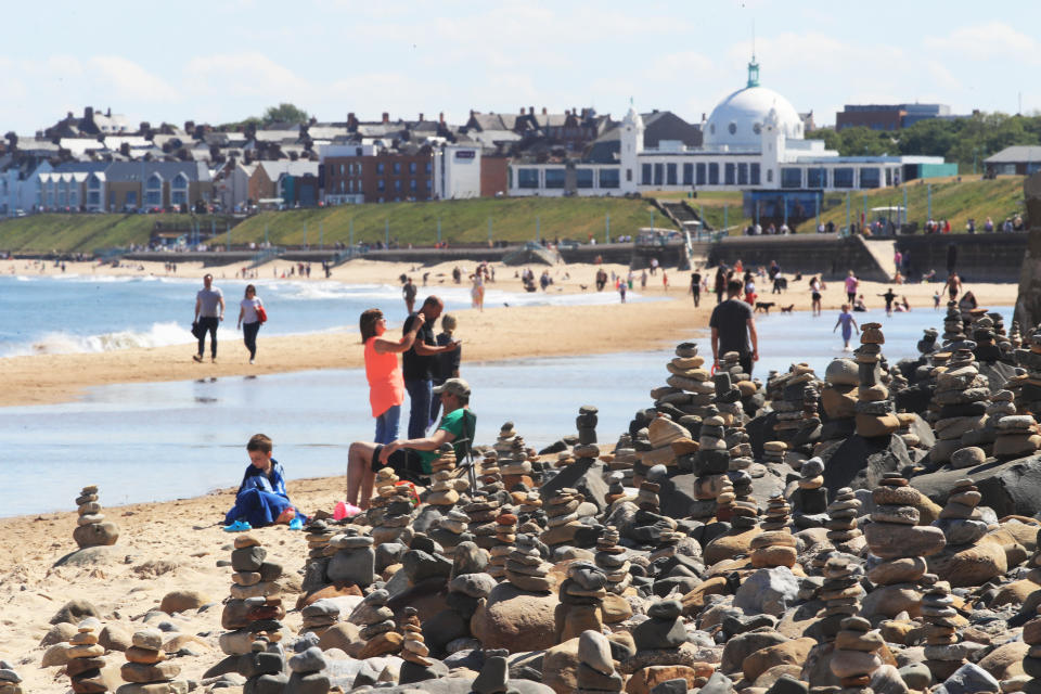 People enjoy the hot weather at Whitley Bay beach in Tyneside as people flock to parks and beaches with lockdown measures eased. (Photo by Owen Humphreys/PA Images via Getty Images)