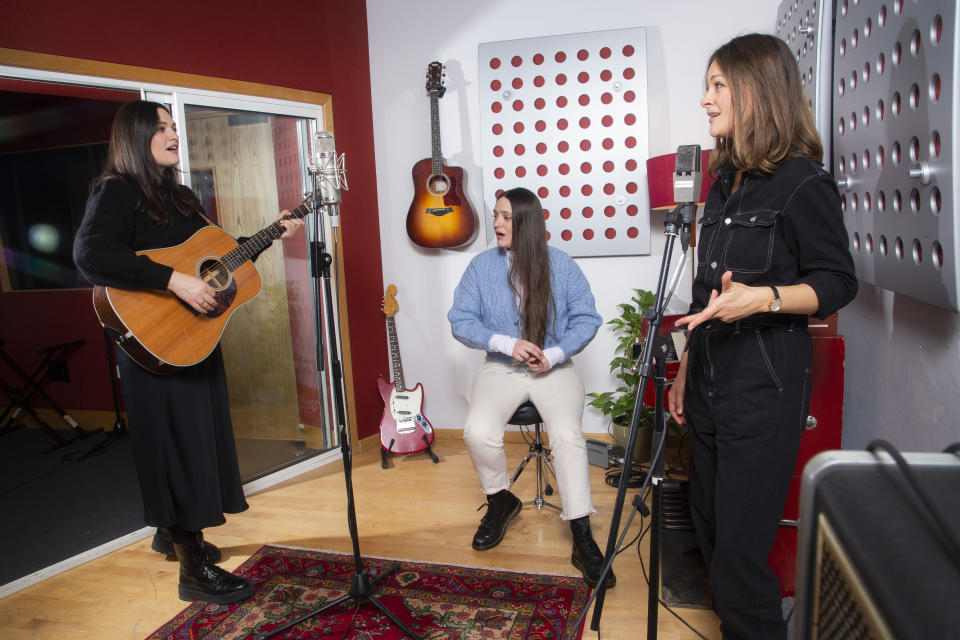 Members of the folk group, The Staves, from left, sisters, Jessica, Camilla and Emily Staveley-Taylor rehearse in a north London recording studio, on Feb. 15, 2021. The Staves released their third album, “Good Woman,” last month. (Photo by Joel C Ryan/Invision/AP)