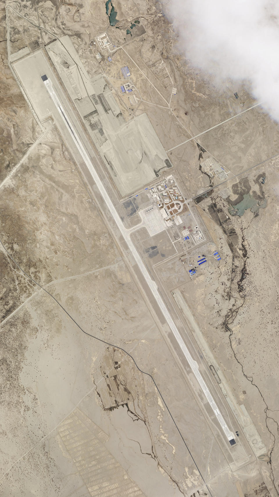 In this satellite image provided by Planet Labs, the Ngari Günsa civil-military airport base taken on May 17, 2020, near the border with India in far western region of Tibet in China shows development around the airport. Tensions along the China-India border high in the Himalayas have flared again in recent weeks. Indian officials say the latest row began in early May, when Chinese soldiers entered the Indian-controlled territory of Ladakh at three different points, erecting tents and guard posts. China has sought to downplay the confrontation while providing little information. (Planet Labs via AP)