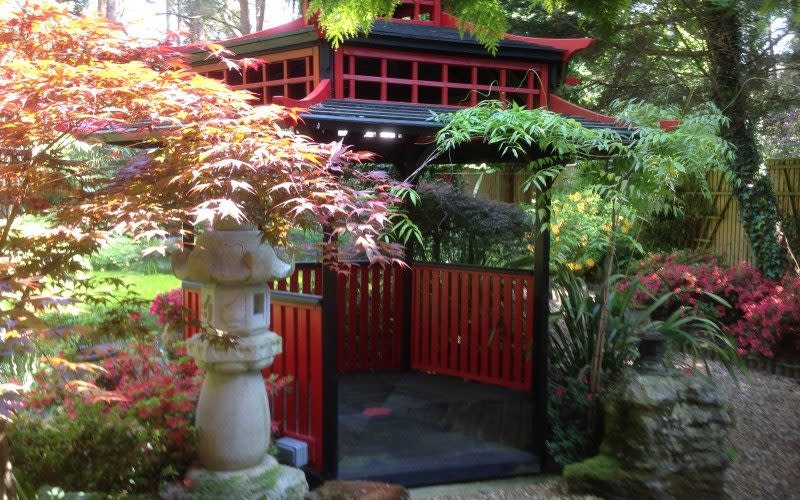 Escape to another world in this Japanese-inspired garden, complete with stone dragons and a bright red and black painted tea house - National Garden Scheme