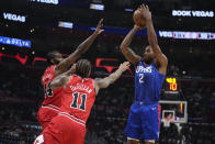 Los Angeles Clippers forward Kawhi Leonard (2) shoots over Chicago Bulls forward DeMar DeRozan (11) and forward Patrick Williams (44) during the first half of an NBA basketball game Monday, March 27, 2023, in Los Angeles. (AP Photo/Marcio Jose Sanchez)