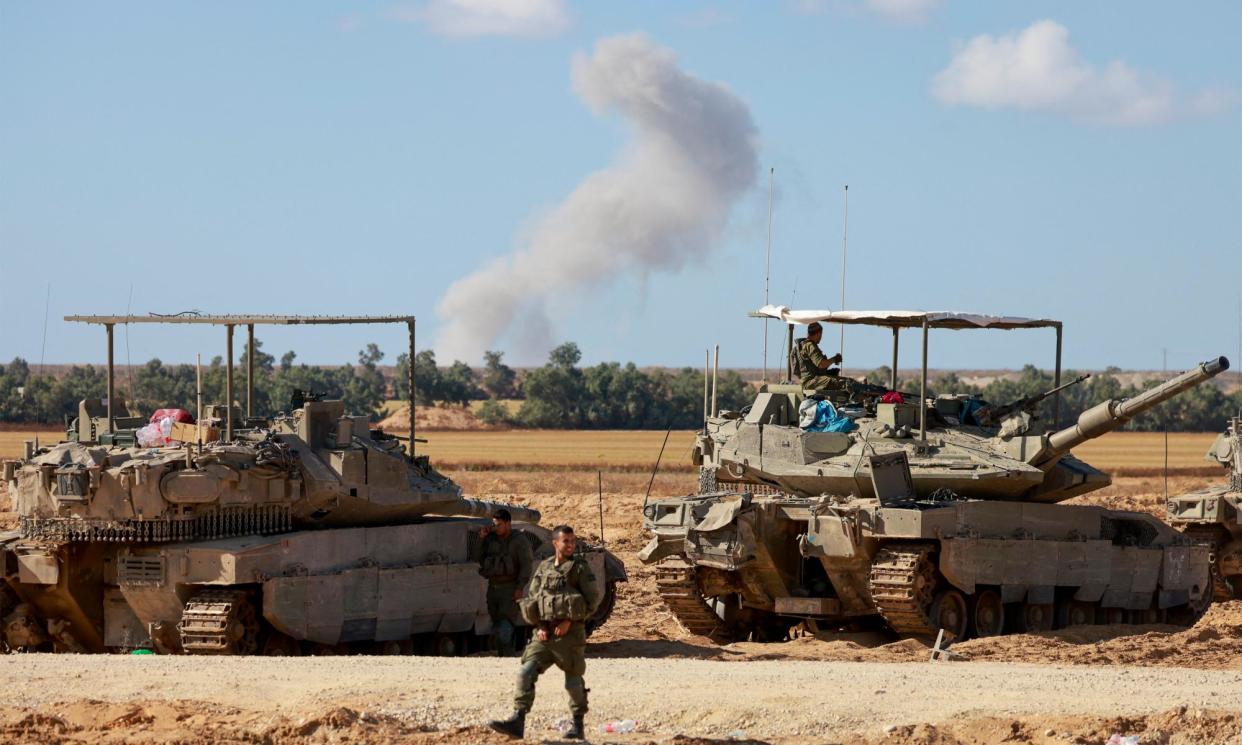 <span>Israeli tanks on the Palestinian side of the Rafah border crossing between Gaza and Egypt.</span><span>Photograph: Menahem Kahana/AFP/Getty Images</span>