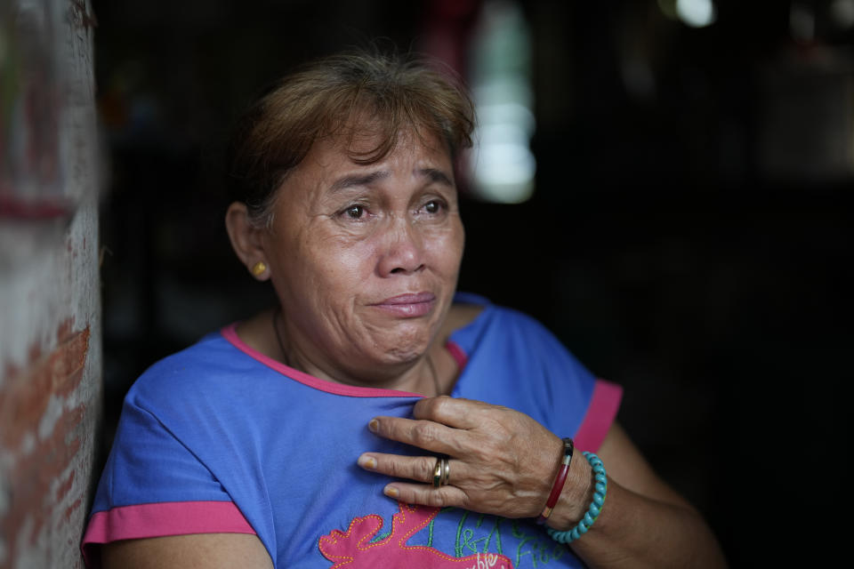 Fish vendor and small store owner Emelita Aberilla reacts as she talks to The Associated Press on Sunday, Oct. 23, 2022 at her home in Anibong village, an area badly hit by Typhoon Haiyan when it struck the province nine years ago, in Tacloban city, central Philippines. Aberilla chose to remain in their typhoon-struck village despite the dangers it poses and the trauma she endured during Typhoon Haiyan. She said there’s work here and the relocation is too far for her. She lost two granddaughters during the typhoon. (AP Photo/Aaron Favila)