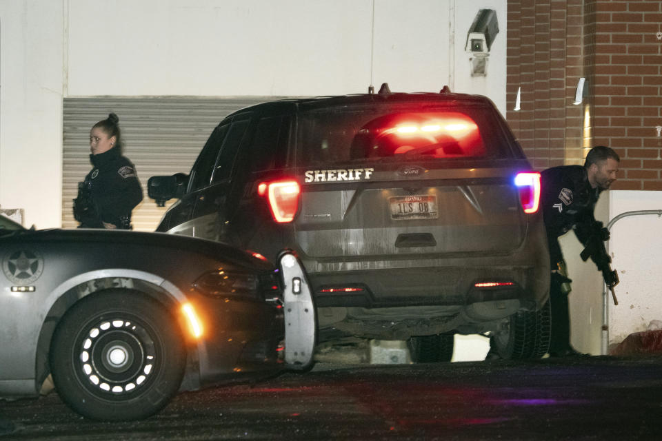 Law enforcement personnel stand guard next to a garage entrance at the Latah County Courthouse after Bryan Kohberger, who is accused of killing four University of Idaho students in November 2022, arrived in a police motorcade at the courthouse, Wednesday, Jan. 4, 2023, in Moscow, Idaho, following his extradition from Pennsylvania. (AP Photo/Ted S. Warren)